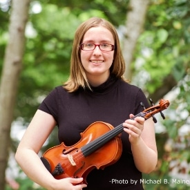 Claire playing violin at Key to Change