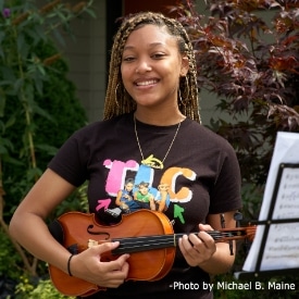 Karahn playing violin at Key to Change