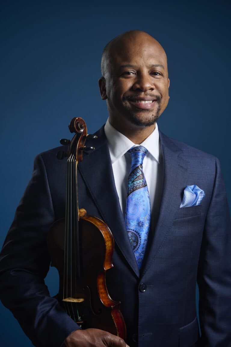 Dr. Morris holding a violin