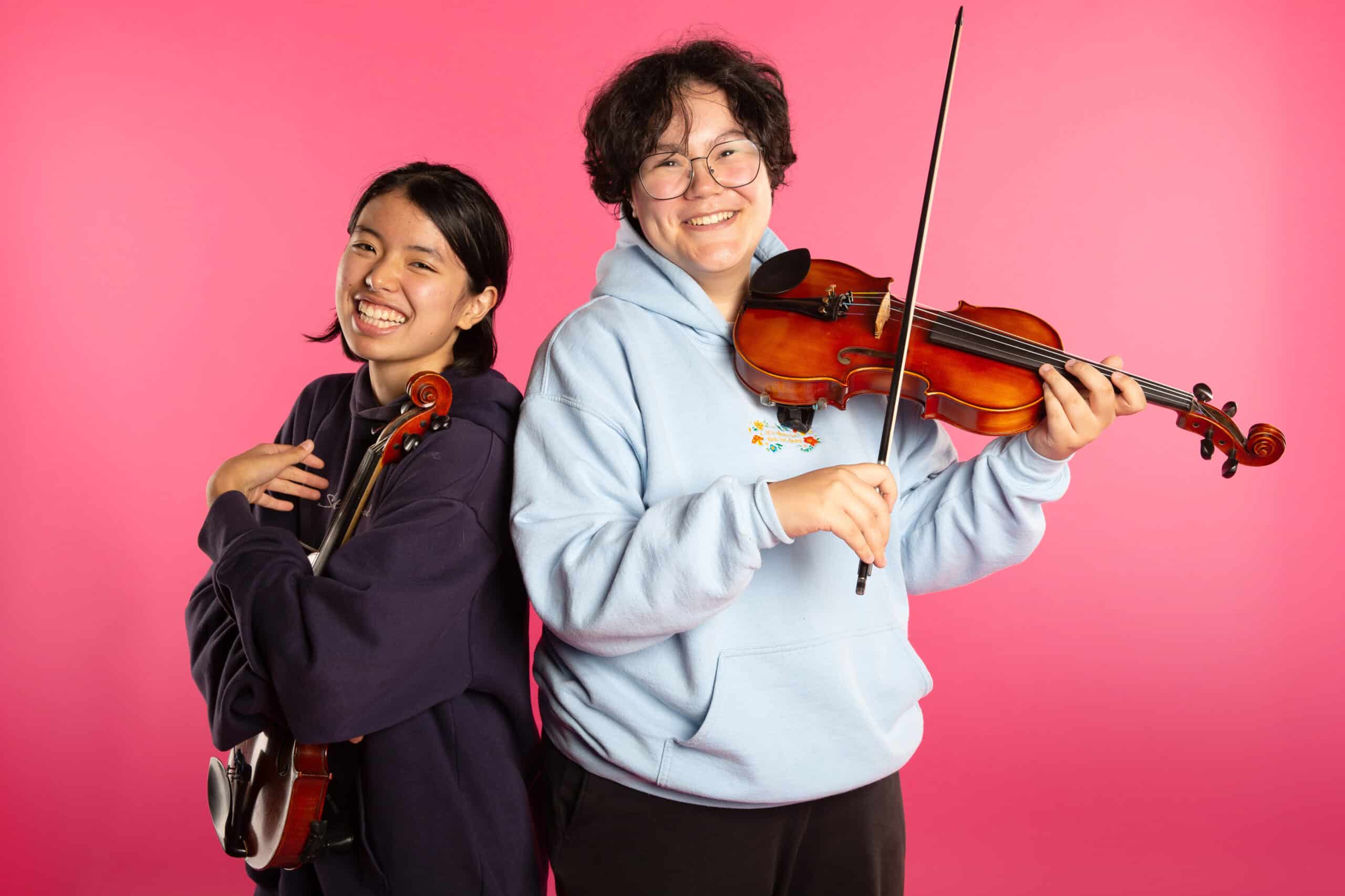 Lynn and Alena holding their violins