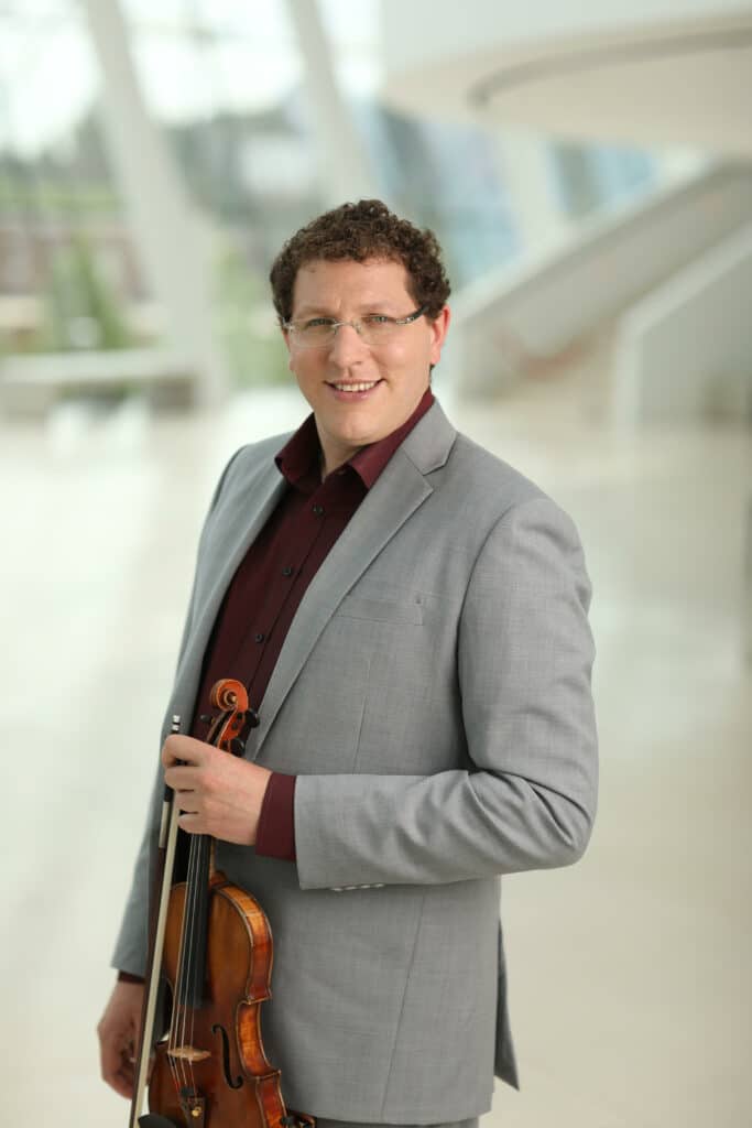 Noah Geller holding a violin