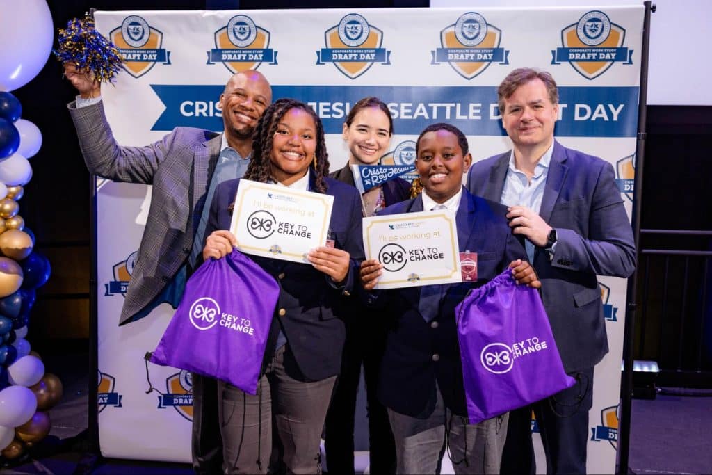 Three staff members of Key To Change Studio in Renton - Dr. Quinton Morris, Dr. Natasha Kubit, and Mr. Robert Simonds, pose for a picture with two students from Cristo Rey Jesuit High School in Seattle.